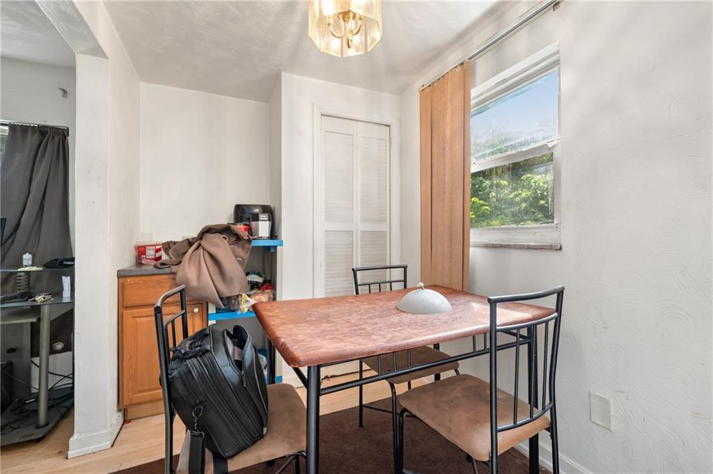 1627-1629 Laketon Road Pittsburgh, PA 15221 - Photo 23 of 26 a view of a dining room with furniture and a window