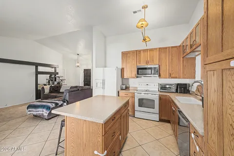 a kitchen with a sink stove and refrigerator