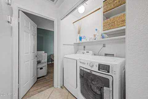 a utility room with cabinets washer and dryer