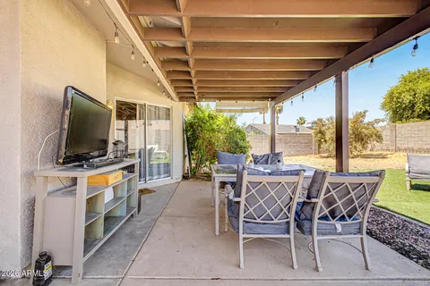 a dining room with furniture a flat screen tv and a window