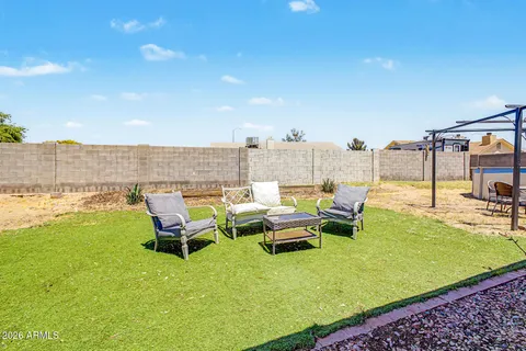a view of a swimming pool with lounge chairs