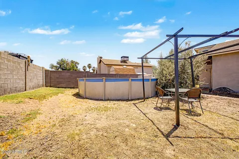 a view of a house with backyard porch and sitting area