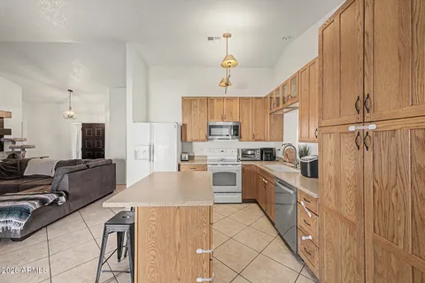 a kitchen with cabinets a sink and appliances
