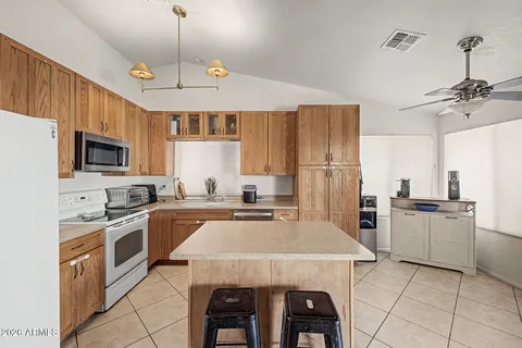 a kitchen with a stove a sink and a refrigerator