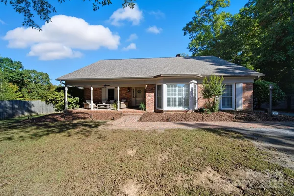 a view of a house with backyard porch and sitting area