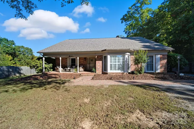 a view of a house with backyard porch and sitting area