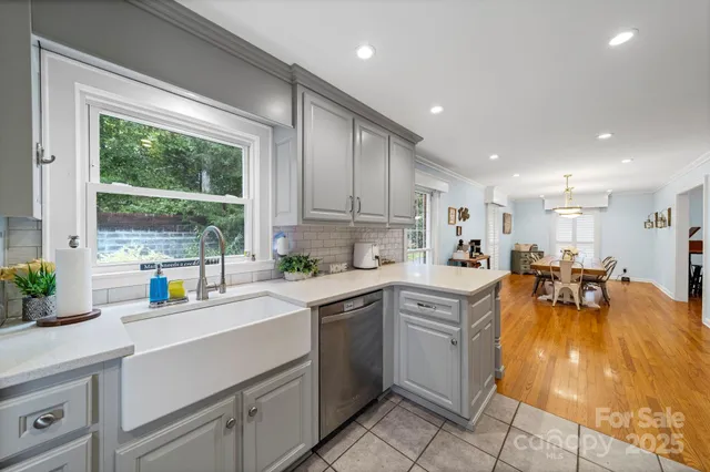 a kitchen with stainless steel appliances a sink and a stove top oven