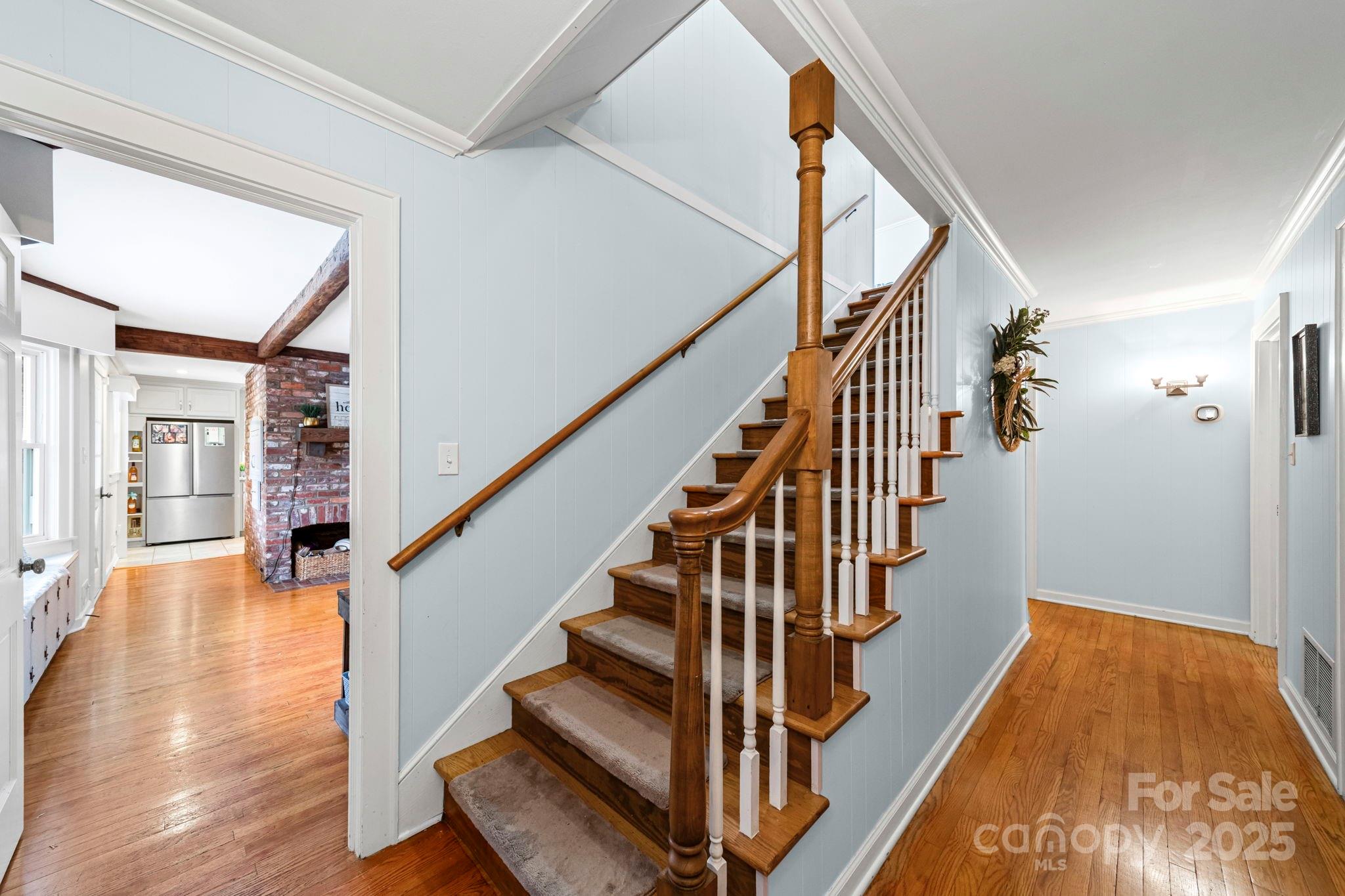 417 Park Ridge Road Albemarle, NC 28001 - Photo 20 of 48 a view of staircase with lots of frames on wall and wooden floor