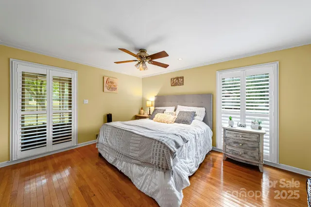a bedroom with a bed and ceiling fan