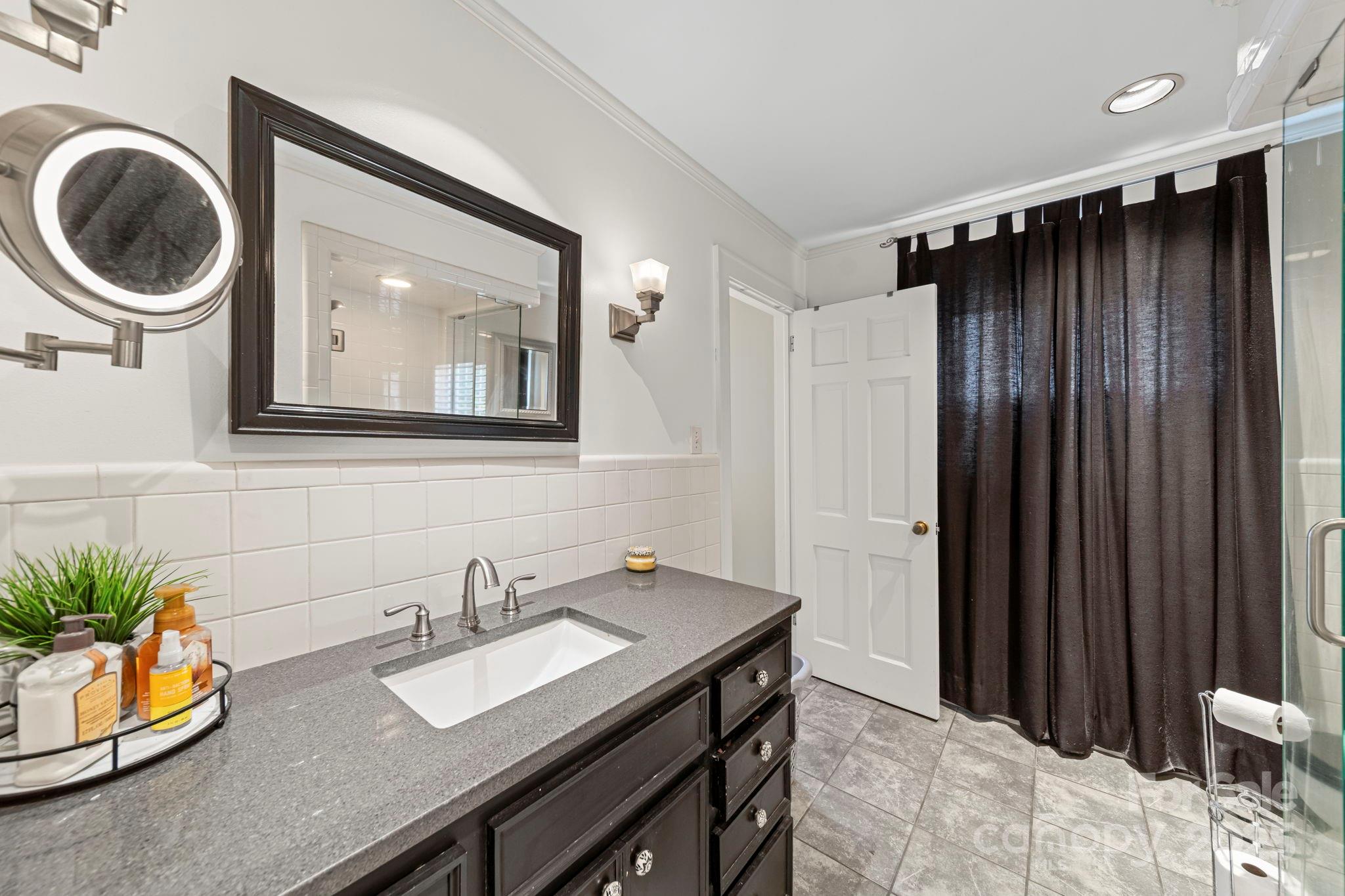 417 Park Ridge Road Albemarle, NC 28001 - Photo 25 of 48 a bathroom with a sink a mirror and a toilet