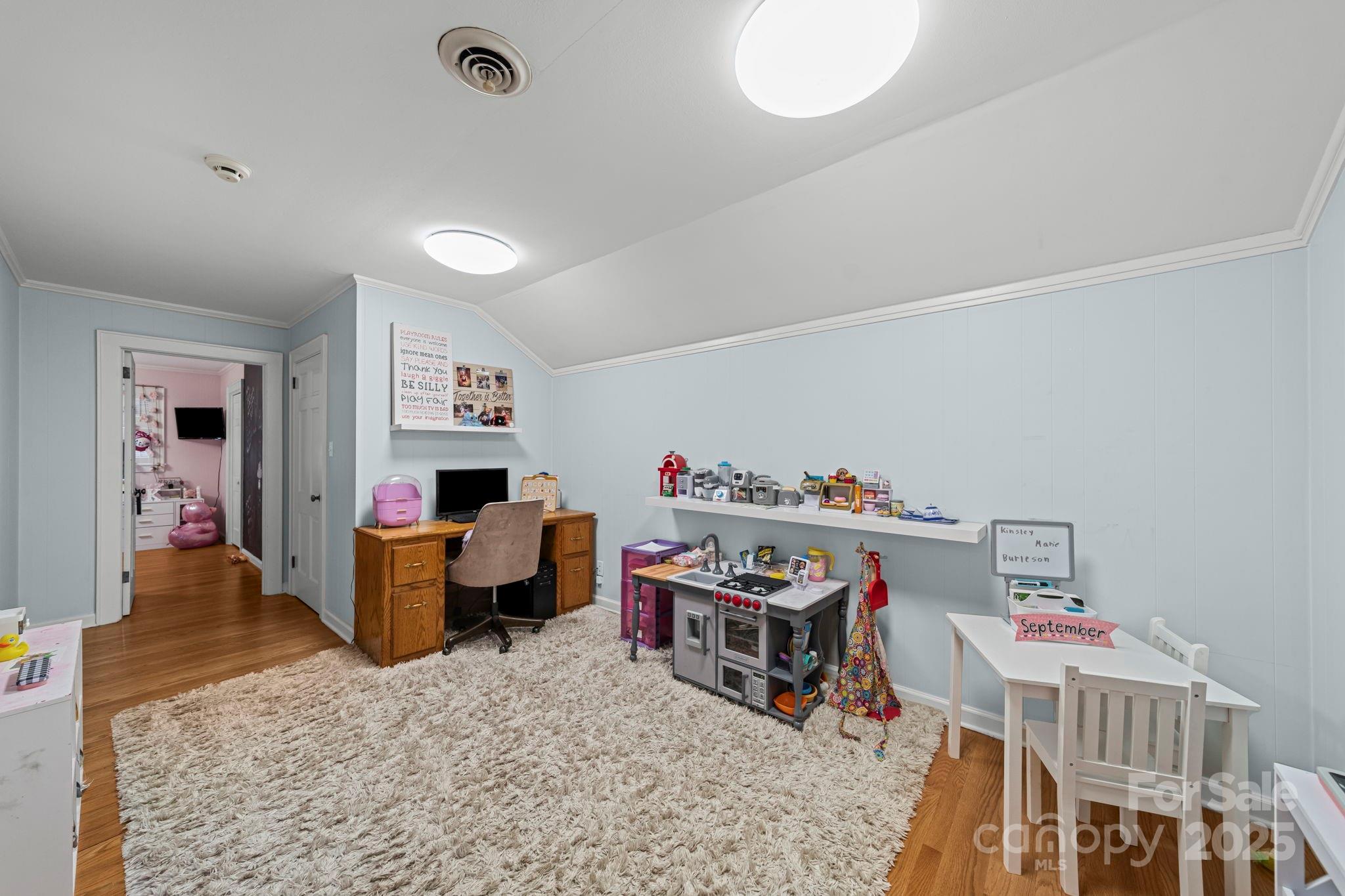 417 Park Ridge Road Albemarle, NC 28001 - Photo 28 of 48 a living room with furniture and a baby crib