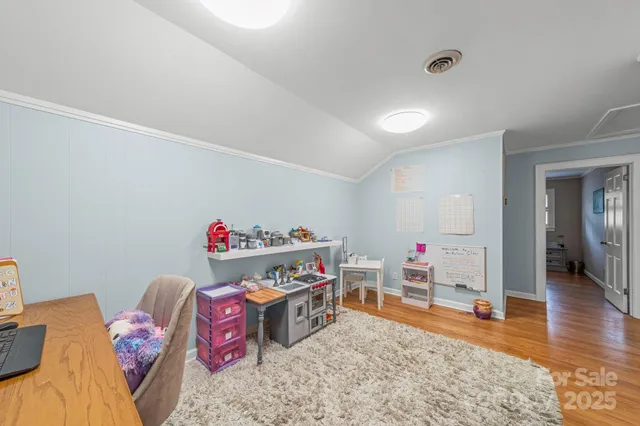 a bedroom with a bed and a wall painting