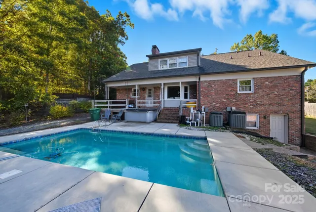 a view of a house with backyard porch and sitting area