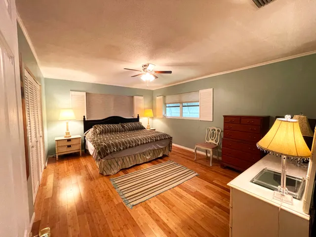 a bedroom with a bed and a night stand