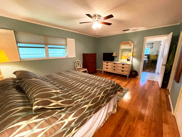 a bedroom with a bed and wooden floor