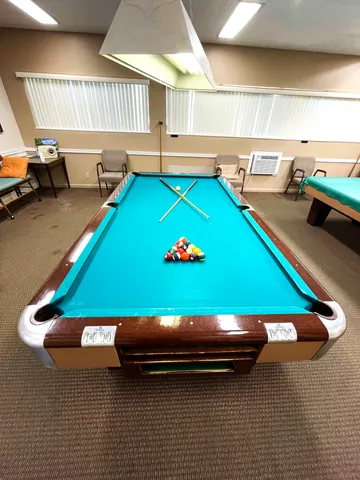 a room with pool table and a couch