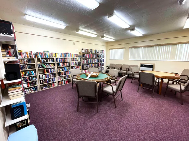 a living room with lots of furniture and a book shelf