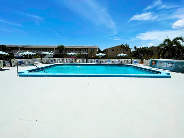 a view of a swimming pool and an outdoor seating
