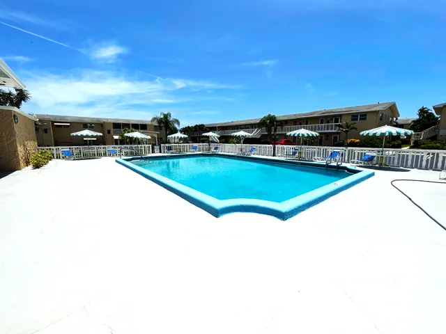 a view of swimming pool with furniture