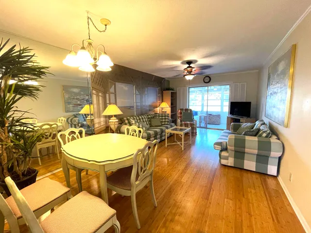 a view of a dining room with furniture window and wooden floor