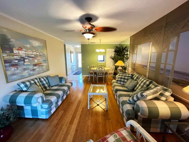 a living room with furniture fireplace and wooden floor
