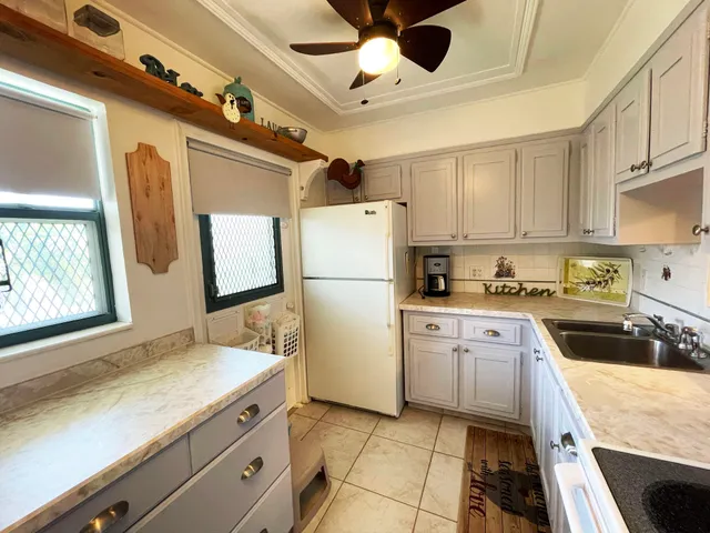 a kitchen with a sink stainless steel appliances a refrigerator and a sink