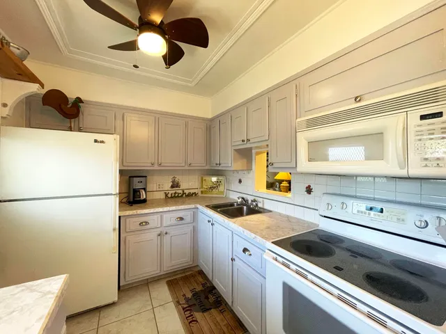 a kitchen with a refrigerator a sink and cabinets