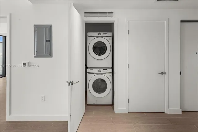 a view of a hallway with washer and dryer