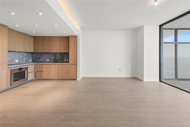 a view of a kitchen with a sink and cabinets