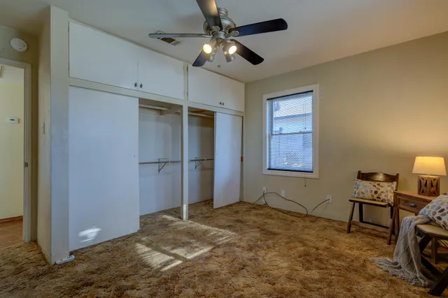 a view of a workspace with furniture and chandelier fan