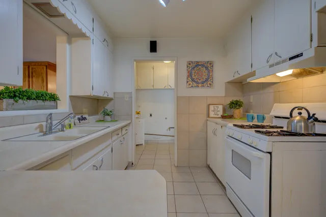 a kitchen with a sink cabinets and window