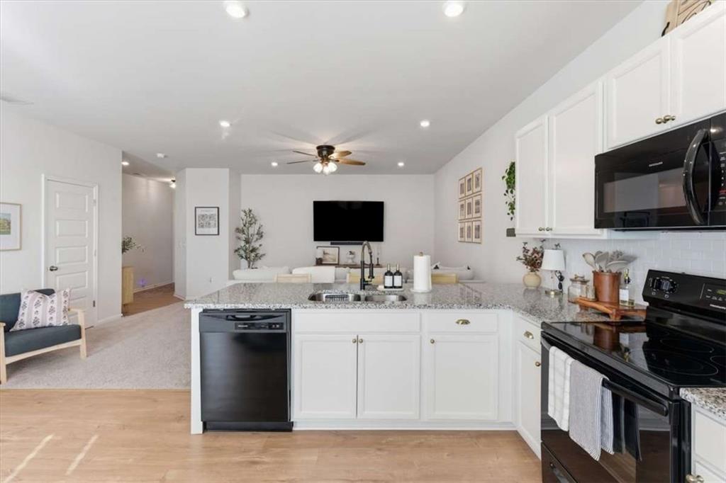 91 Pinnacle Way Jasper, GA 30143 - Photo 12 of 37 a kitchen with stainless steel appliances granite countertop a sink and a stove