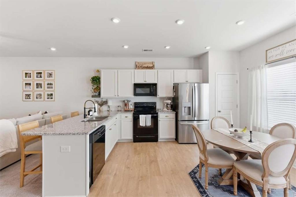 91 Pinnacle Way Jasper, GA 30143 - Photo 13 of 37 a kitchen with a refrigerator a stove a sink dishwasher with a dining table and chairs