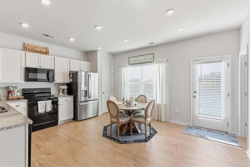 91 Pinnacle Way Jasper, GA 30143 - Photo 14 of 37 a kitchen with refrigerator a sink and chairs