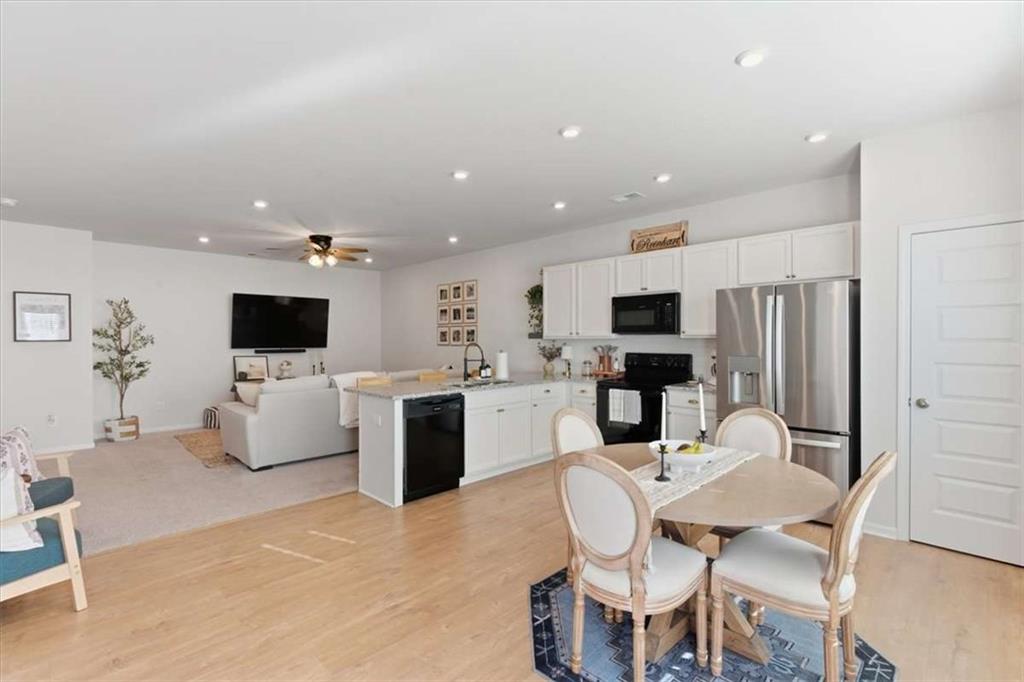 91 Pinnacle Way Jasper, GA 30143 - Photo 16 of 37 a kitchen with stainless steel appliances kitchen island granite countertop a sink and a refrigerator