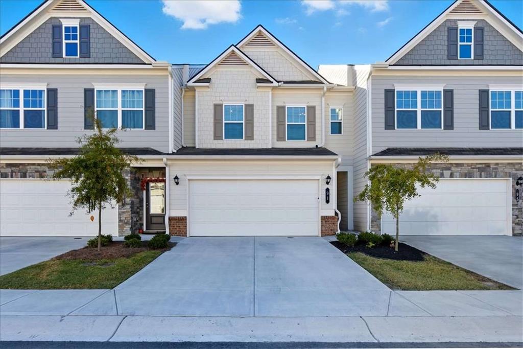91 Pinnacle Way Jasper, GA 30143 - Photo 2 of 37 a front view of a house with a yard and garage