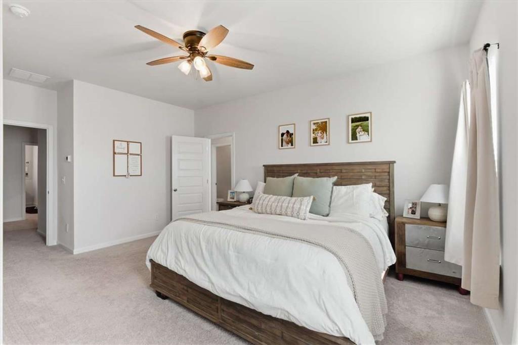 91 Pinnacle Way Jasper, GA 30143 - Photo 21 of 37 a bedroom with a bed and a ceiling fan