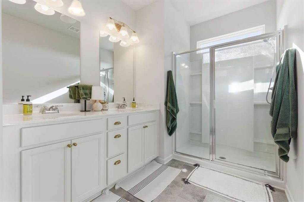 91 Pinnacle Way Jasper, GA 30143 - Photo 24 of 37 a bathroom with a double vanity sink mirror and shower