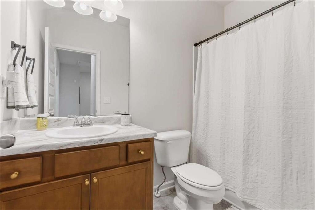 91 Pinnacle Way Jasper, GA 30143 - Photo 27 of 37 a bathroom with a granite countertop sink toilet and mirror