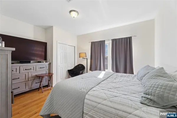 a bedroom with a bed and a closet