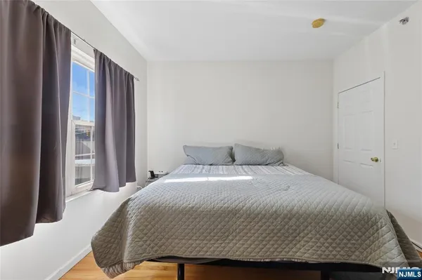 a kitchen with stainless steel appliances a stove a sink dishwasher and a refrigerator with wooden floor