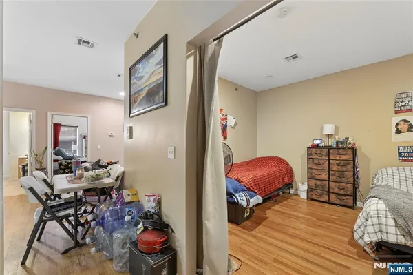 a kitchen with granite countertop a sink cabinets stainless steel appliances and a window