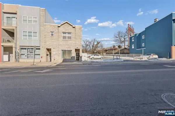 a view of a hallway with wooden floor and entryway