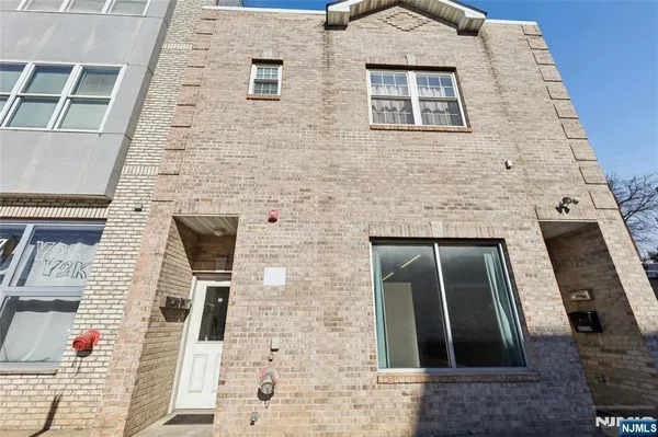 a kitchen with a refrigerator a stove and a dining table