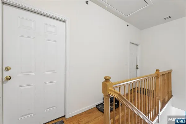 a bedroom with bed and a wooden floor