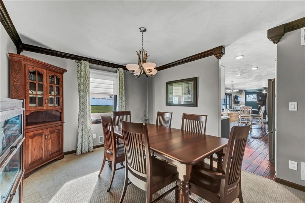 144 Wetzel Road Sarver, PA 16055 - Photo 23 of 48 a dining room with furniture a chandelier and wooden floor