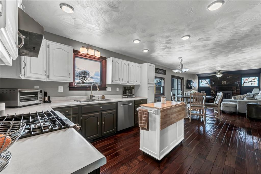 144 Wetzel Road Sarver, PA 16055 - Photo 25 of 48 a kitchen with stainless steel appliances a stove a sink dishwasher a refrigerator white cabinets and wooden floor