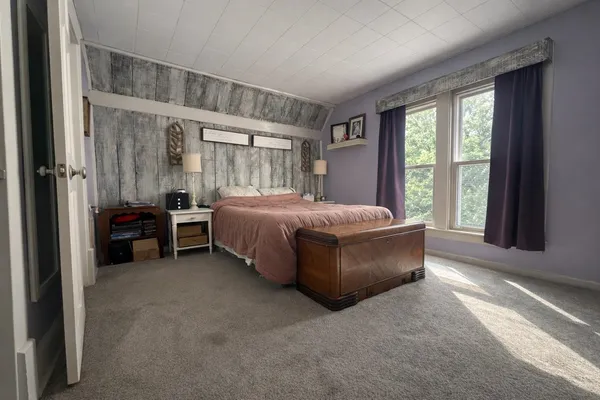 a bed room with a bed and a chair