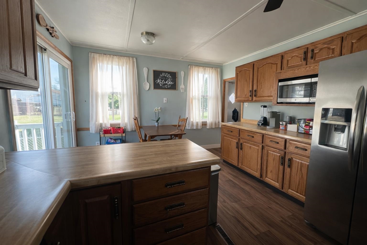 307 South 5th Street Oregon, IL 61061 - Photo 8 of 18 a kitchen with stainless steel appliances granite countertop a sink dishwasher stove and wooden cabinets