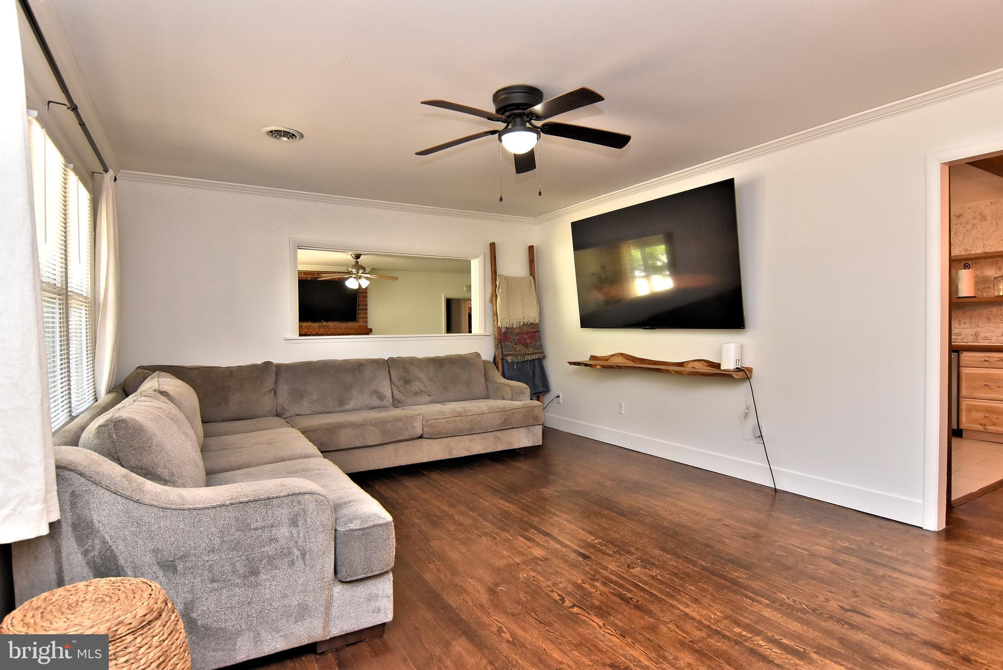 9012 Concord Road Seaford, DE 19973 - Photo 10 of 24 a living room with furniture and a flat screen tv